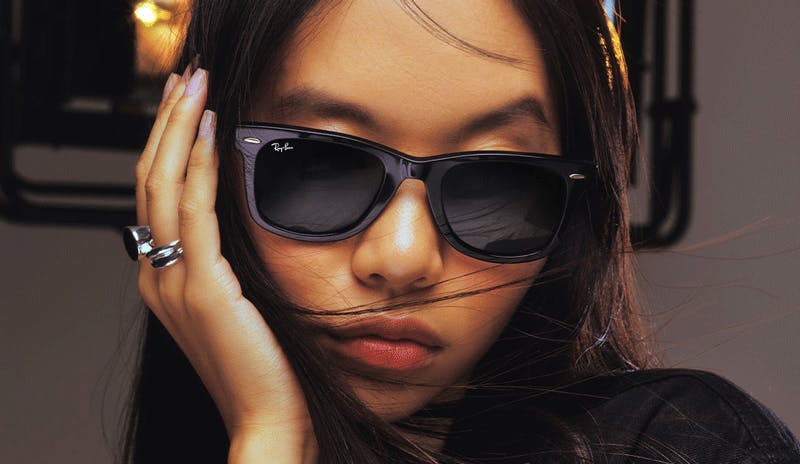 Girl wearing Ray-Ban Wayfarer sunglasses.