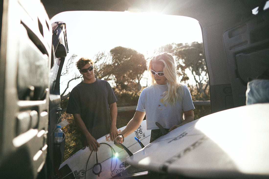 two people wearing Dragon sunglasses going surfing 