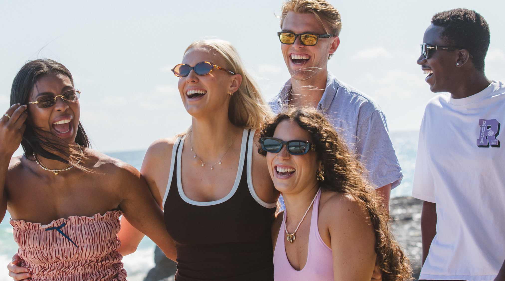 Friends wearing sunglasses on the beach