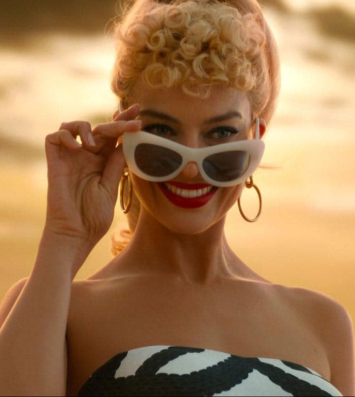 Margot Robbie as Barbie wearing sunglasses