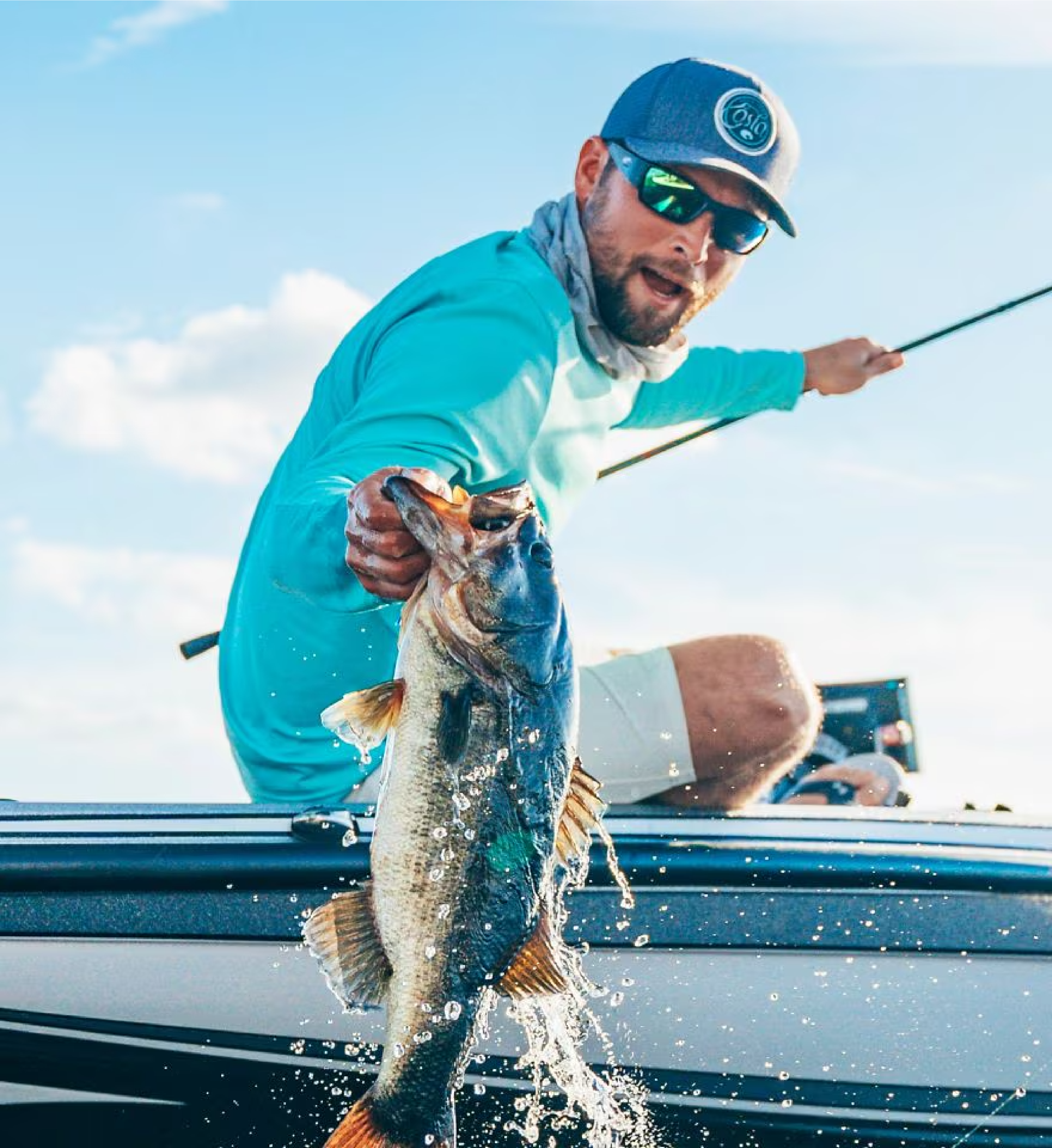 Man wearing fishing sunglasses holding a large fish caught from a boat on a sunny day 