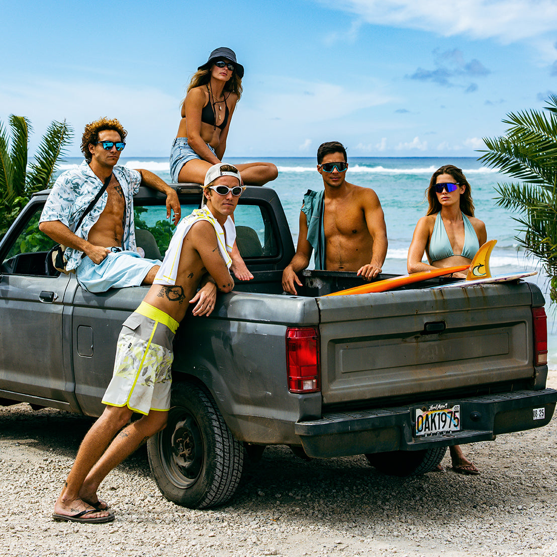 Friends at the beach wearing Oakley Sunglasses