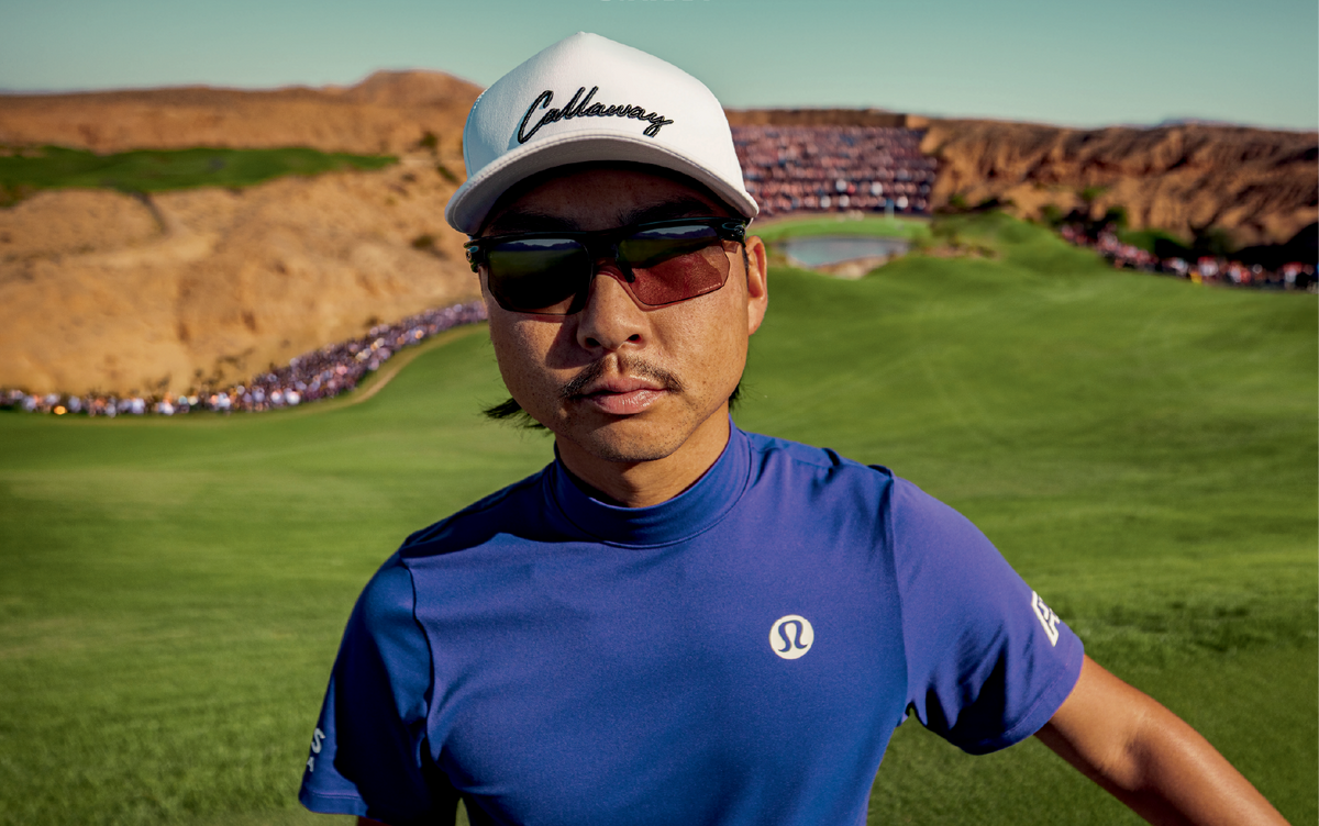 A male golfer wearing a white Callaway capa and  dark Oakley sunglasses