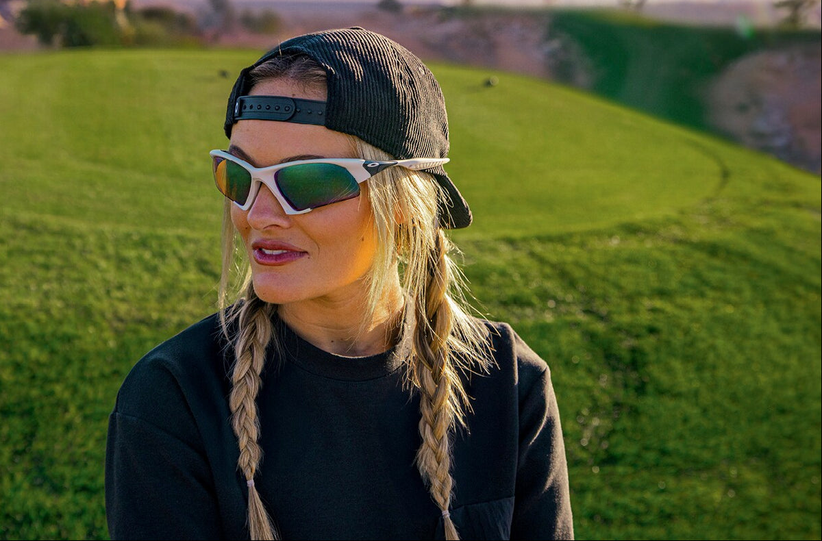 Person wearing oakley  sunglasses with a blurred golf course background