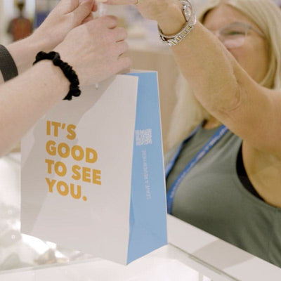 Person holding Just Sunnies bag