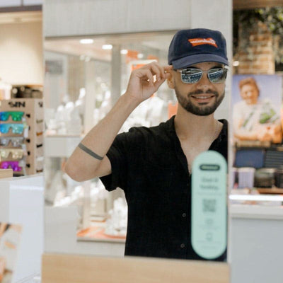 Man wearing a cap and sunglasses in Just Sunnies store